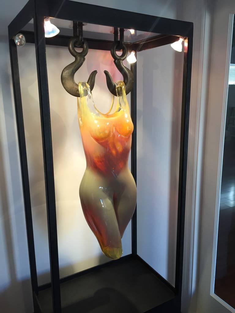 Beautiful handblown glass female figure hanging in cast bronze frame, hot sculpted blown glass. Comes with black pedestal. Glass sculpture. 

Measures: Glass 

Height 32 inches.
Depth 8 inches.

Iron frame:
Height 53 inches.
width