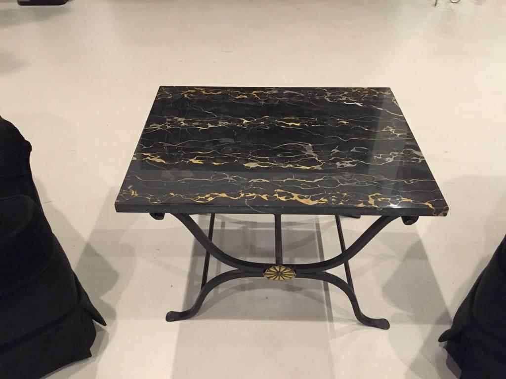 This 1930s French Art Deco wrought iron occasional or coffee table has a rare old Portoro marble top with “heartbeat” veining. Hand-wrought brass florettes adorn each side of the table.
 