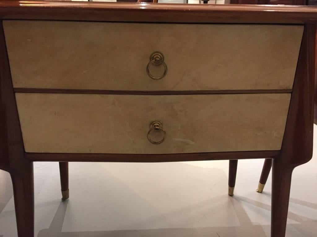 A beautiful pair of Italian Mid-Century Modern nightstands. Two drawers on one of them and swinging doors on the other. With original pulls and sabots. Perfect for bedside as well as living room.
