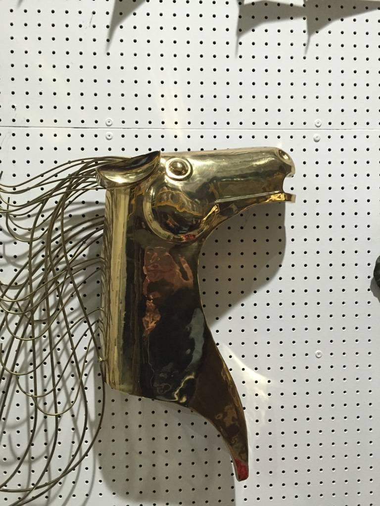 Curtis Jere wall sculpture of gold horse. This piece is signed on a rod of the mane with C. Jere 1984, brass wall sculpture of stylized horse.
