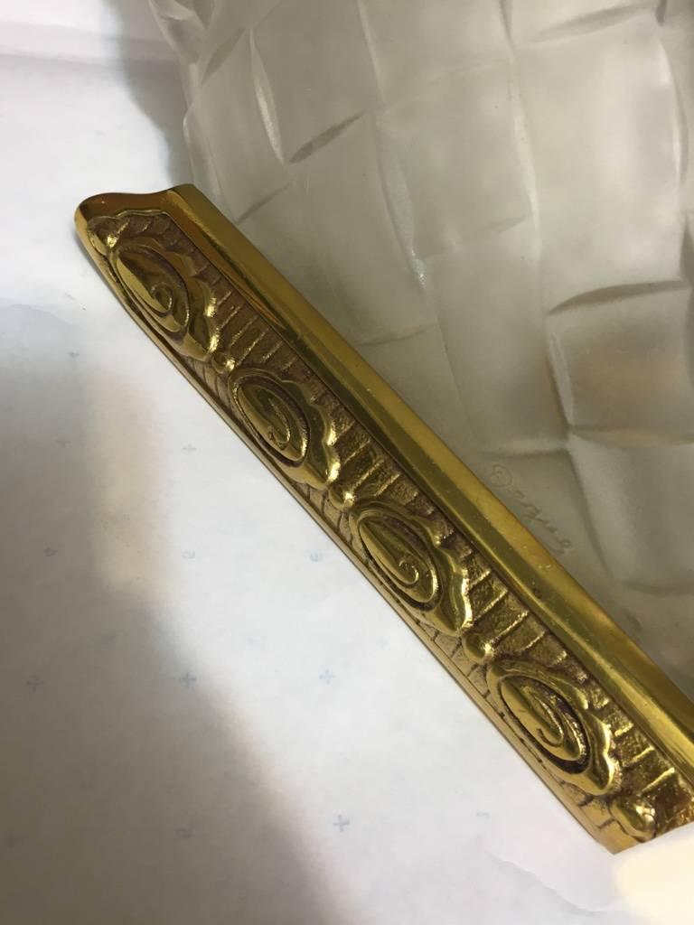 Set of four French Art Deco sconces signed by Degue. Clear frosted glass shades with floral basket motifs. Held by brass deco frames. Has been re wire for American use. Re plating upon request. 



