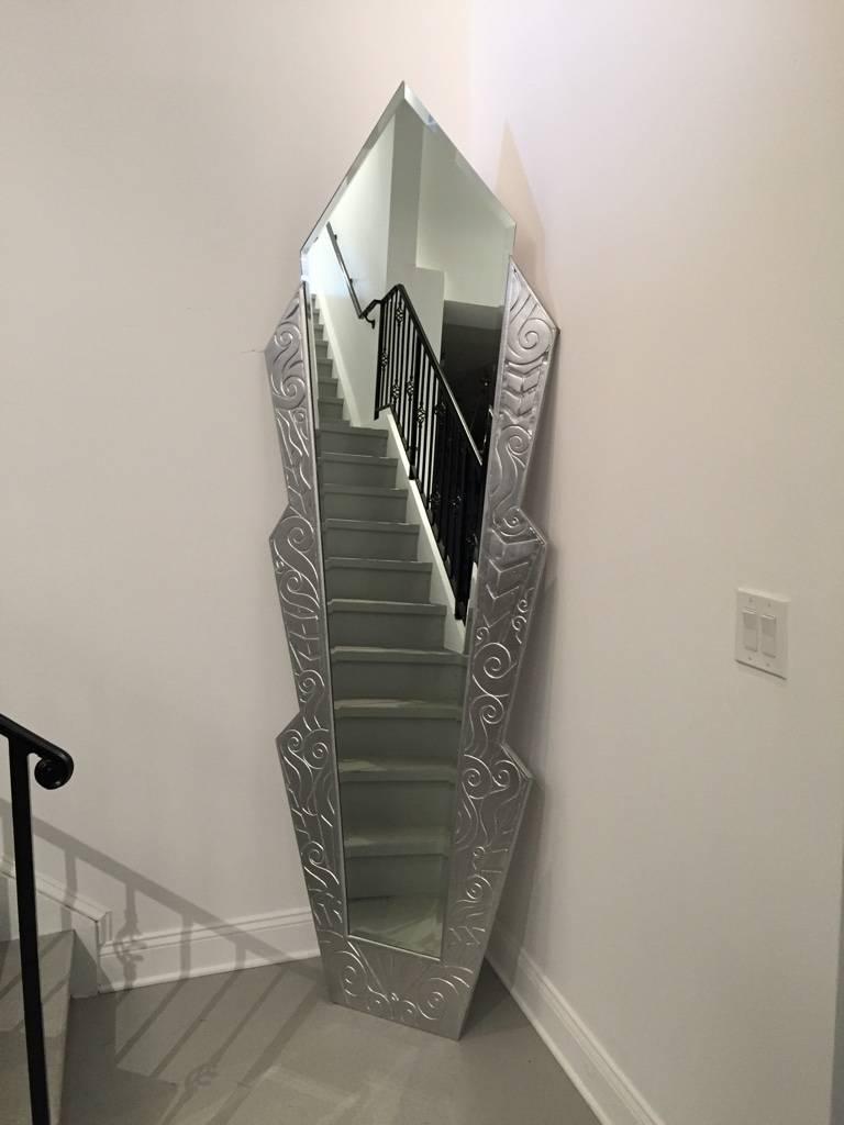 Stunning monumental French Art Deco silvered wood mirror.  Having incredible geometric and deco details carved into the wood. This mirror makes a great focal point of any room. Full length Mirror. 