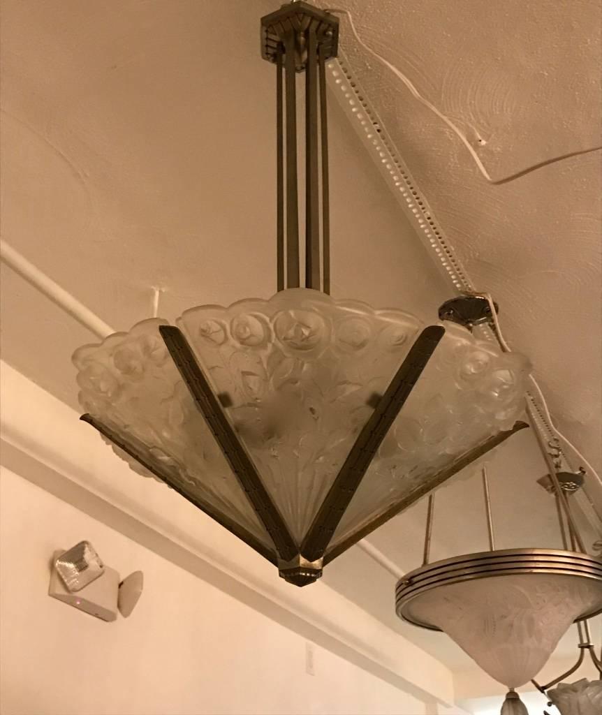 Stunning French Art Deco chandelier signed by Verrerie Des Hanots. With six clear frosted rose floral panels. Polished details on a nickel frame with a geometric design. Matching sconces available. Re-plating upon request. Has been rewired for