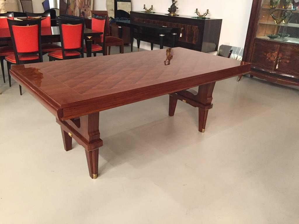 Stunning French Art Deco high polish dining table with brass hardware. The top of the table has geometric design with very stylish legs.