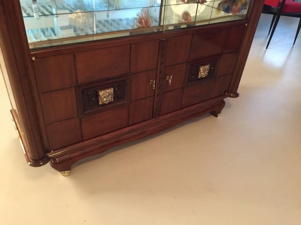 Stunning French Art Deco bronze face walnut vitrine / dry bar. This dry bar has been professionally refinished having a very high French polish. The two center doors have a floral bronze face with beautiful deco details.