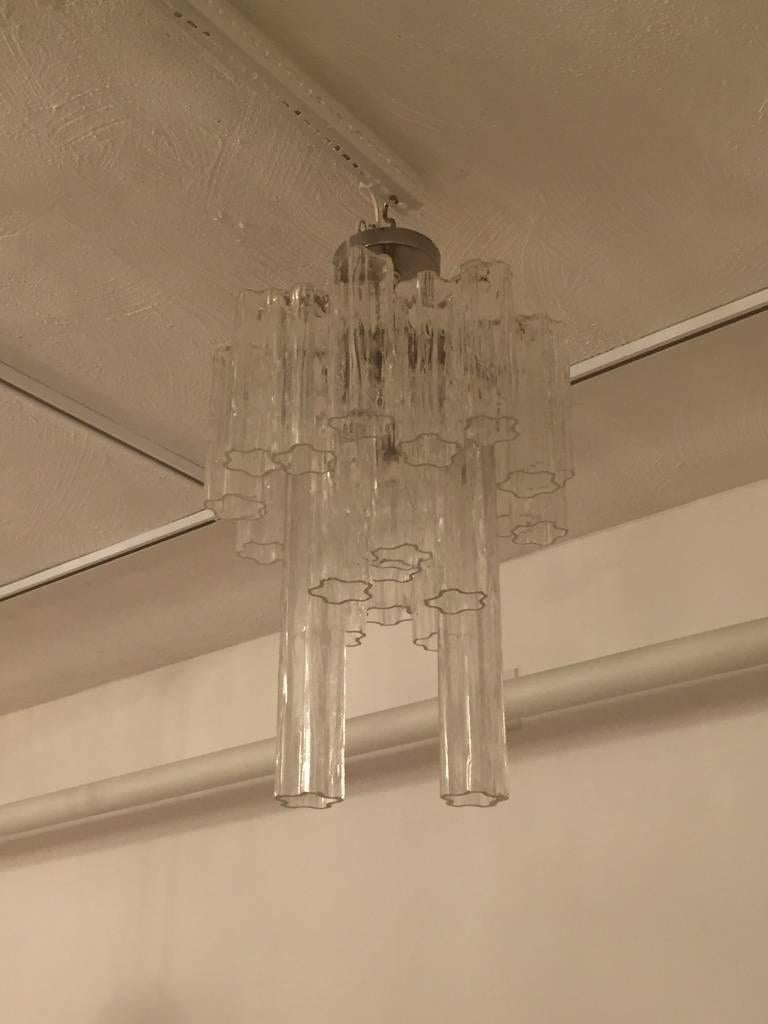 Mid-Century Modern Italian round tronchi chandelier. The glass tronchi tubes hang from hooks onto a nickel frame, as pictured. Any amount of chain or rod can be added for custom hanging length of the chandelier.