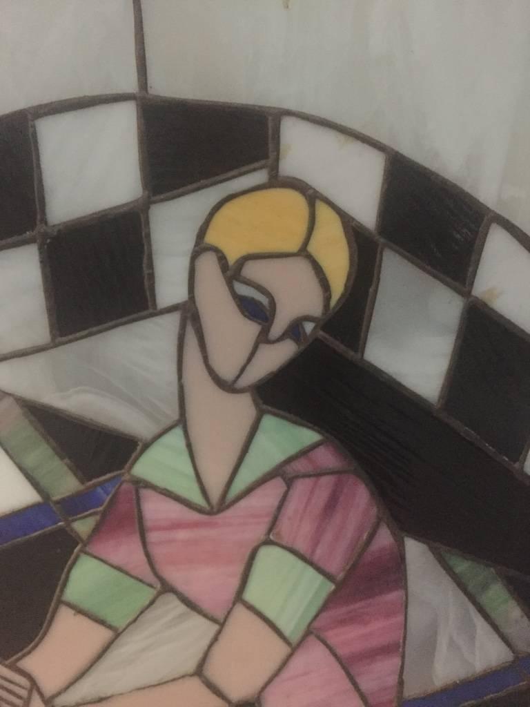 Art Deco stained glass of women playing tennis signed by M Adler. With pink wood frame. 

