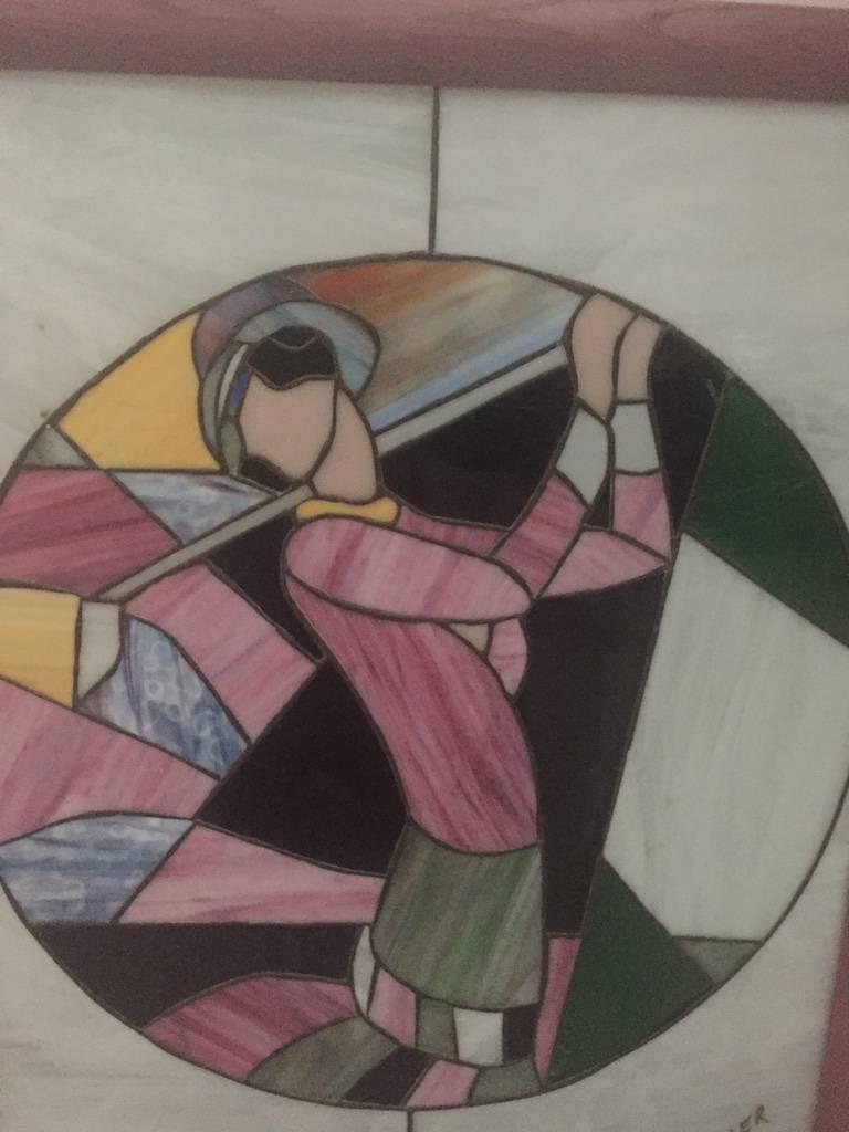 Art Deco stained glass of women playing golf signed by M Adler with pink wood frame.