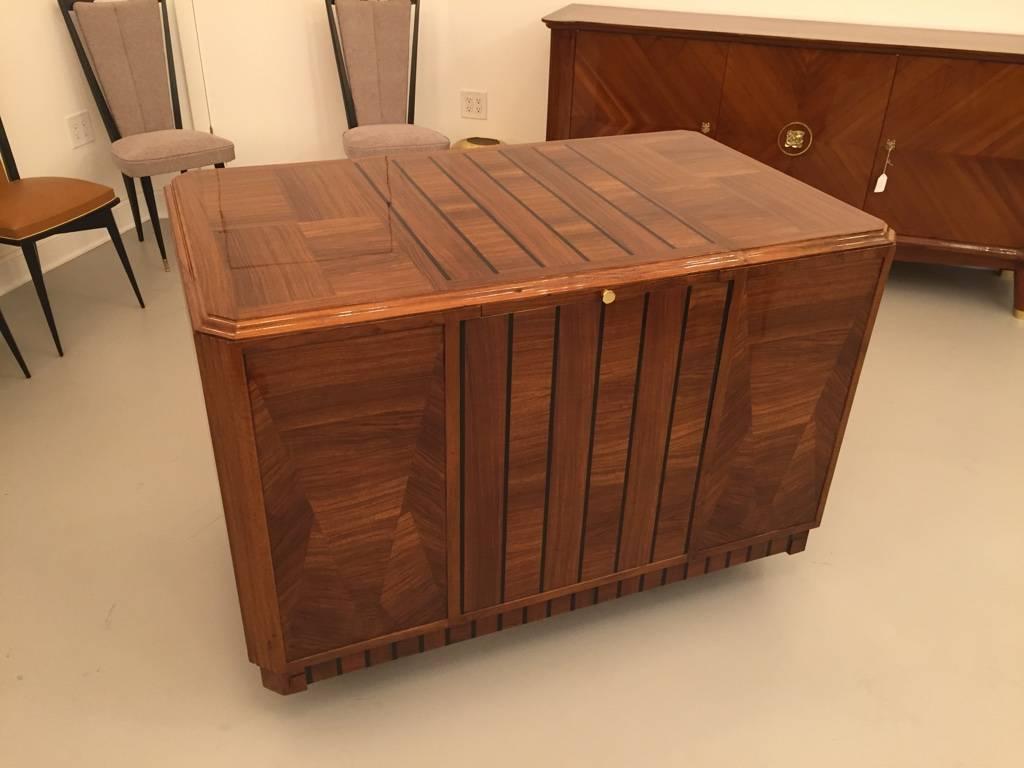 Stunning French Art Deco desk with pull-out secretary table. Having beautiful Deco lines and brass hardware. All the locks work making this a functional desk. The hardware accents the wood beautifully. Having a high French polish. Perfect for any