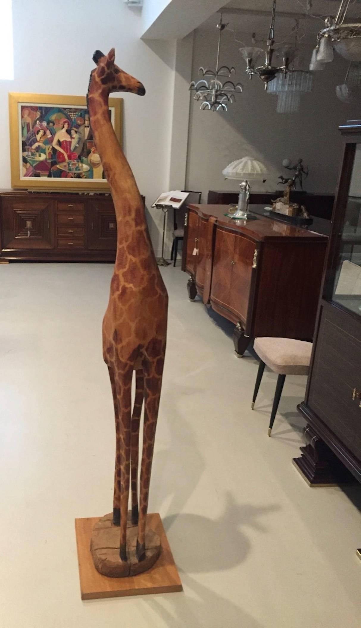 Beautiful hand-carved wood standing giraffe. Standing over 5 feet tall with exceptional caved details.