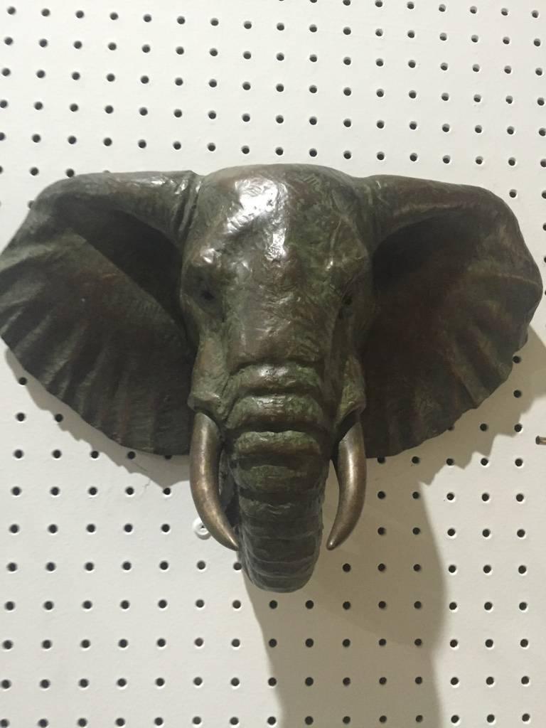 Pair of Mid-Century bronze elephant heads. Verde and gold patina. Incredible details. Slight color variation between the two elephant heads.