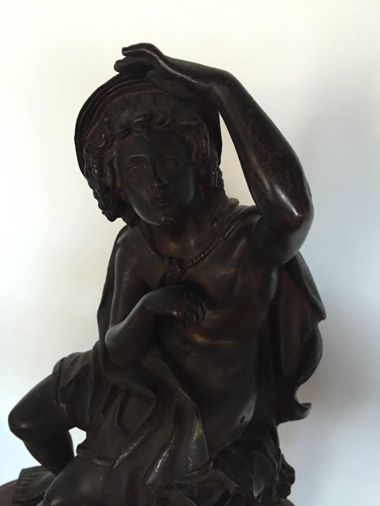 Stunning 19th century rare bronze of seated man figure. The attention to detail is incredible. Having a man looking into the distance while sitting on two heads of Egyptian style motif. Supported on a rouge marble base. Very beautiful detail. Signed