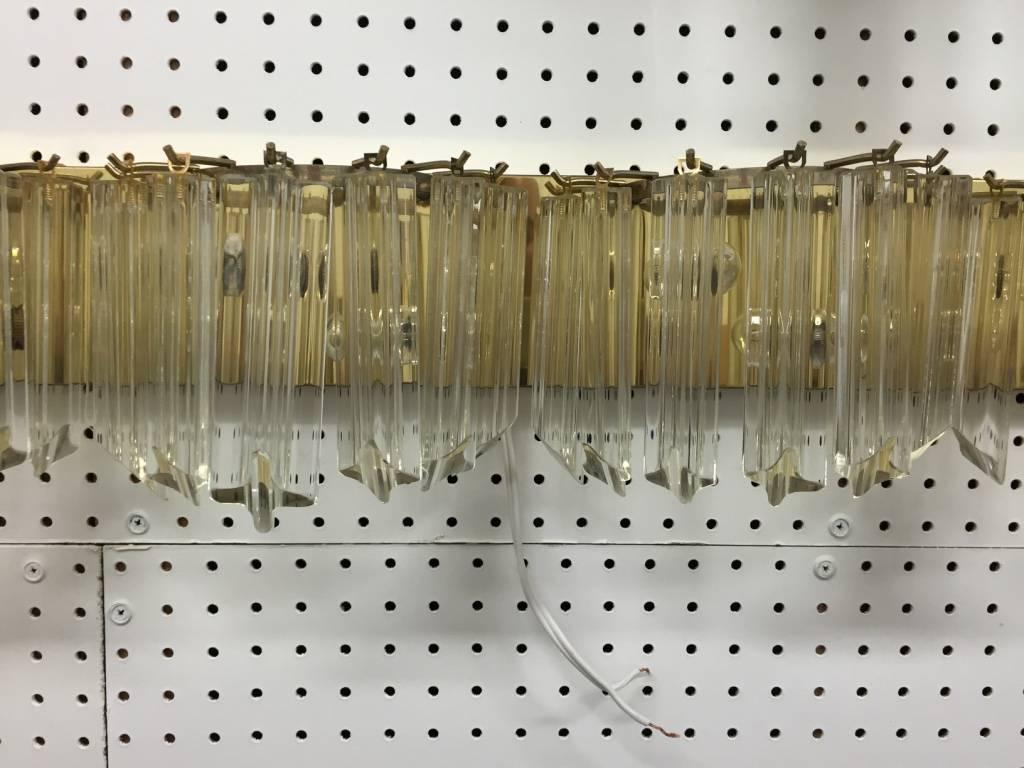 Italian Mid-Century Modern 34.5 inch horizontal sconce by Venini. Having a brass frame with beautiful 6 inch glass prisms.