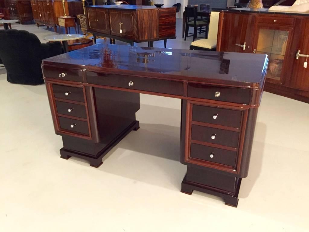 Gorgeous French Art Deco two-tone desk table. Having beautiful Deco lines and silver hardware. All the locks work making this a functional desk. The hardware accents the wood beautifully. Having a high French polish. Perfect for any Deco lover.