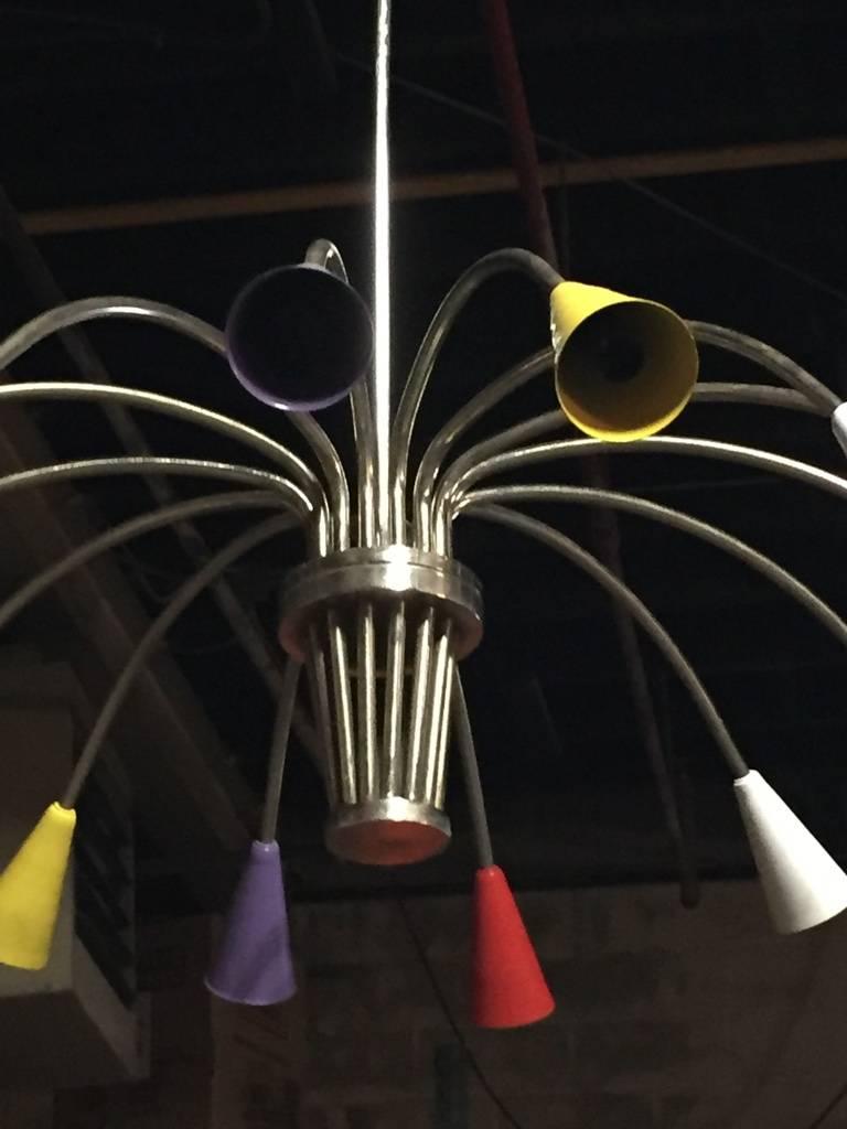 Stunning Italian Mid-Century Modern chrome and multicolor metal cone form shade chandelier. Having central hub supporting 14-arms.