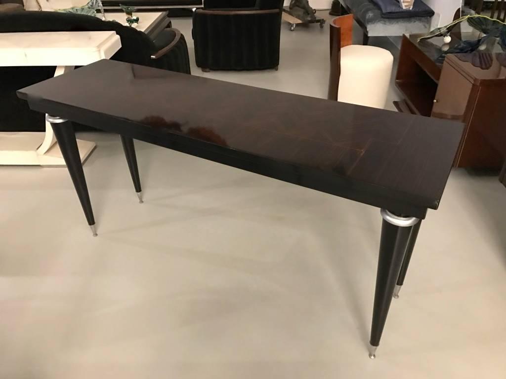Stunning French Art Deco console table. Having spectacular inlay with ebony legs. The silver hardware accents the wood beautifully. Deco details throughout.