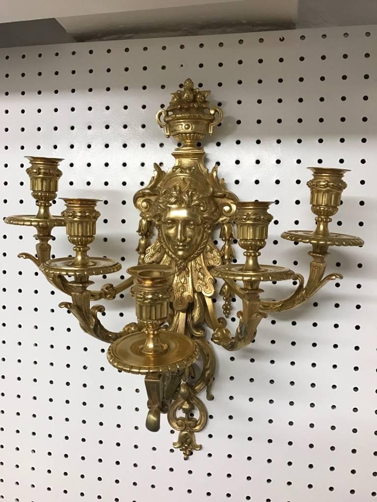 Stunning pair of five-light brass candelabra sconces. Depicting a 