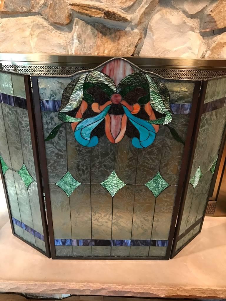 Stained glass fire screen having three beautiful panels of floral motif.
