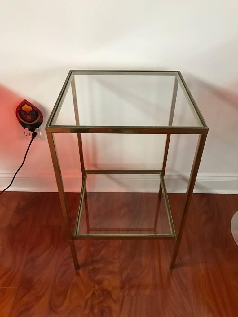 Stunning Mid-Century Modern brass and glass side table having two tiers.
