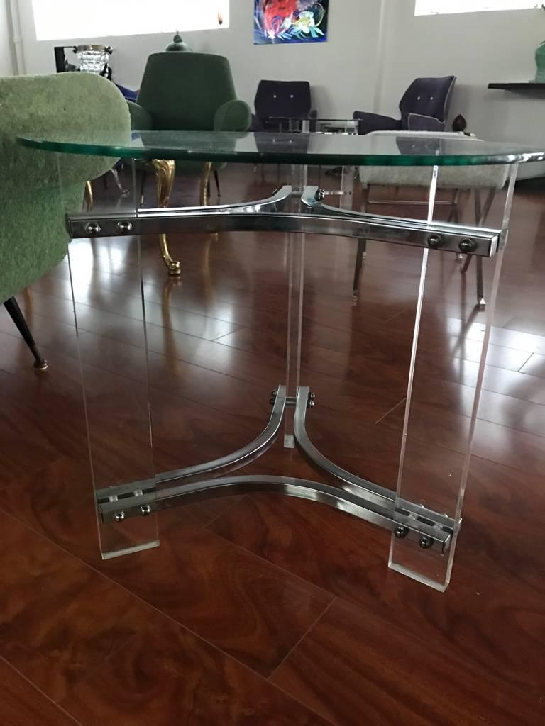 Stunning pair of Mid-Century Modern end tables. Having chrome, Lucite and glass circular top.