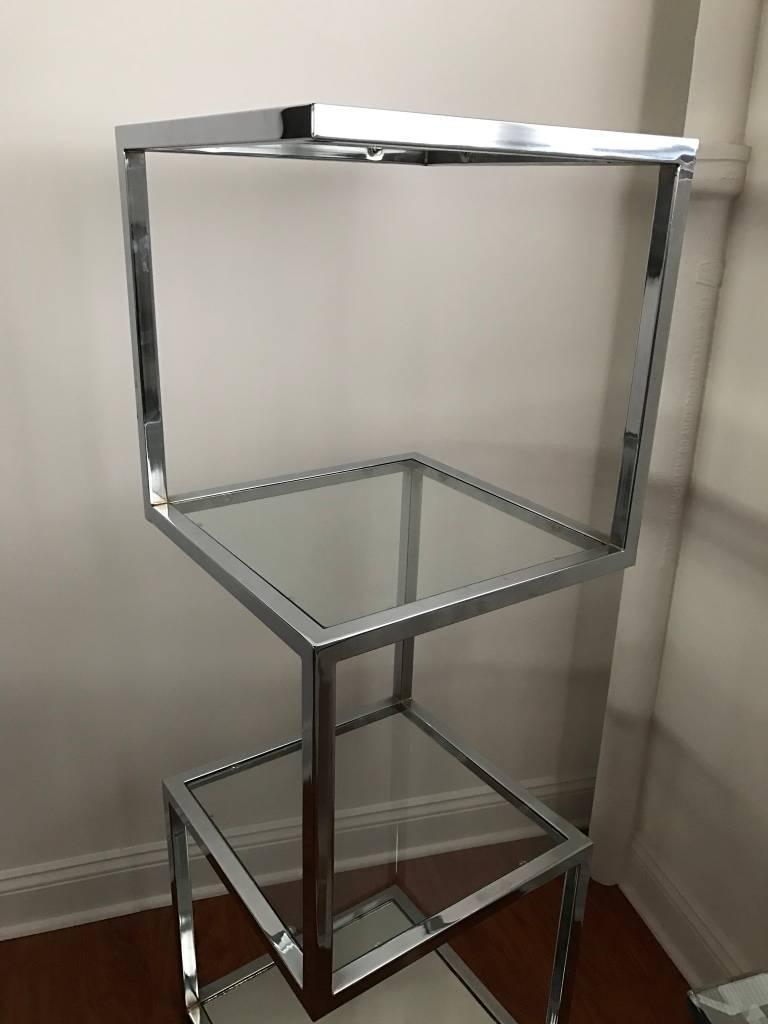 Stunning Mid-Century Modern chrome display case. Having four shelfs. The bottom shelve having mirror while the other three are glass.