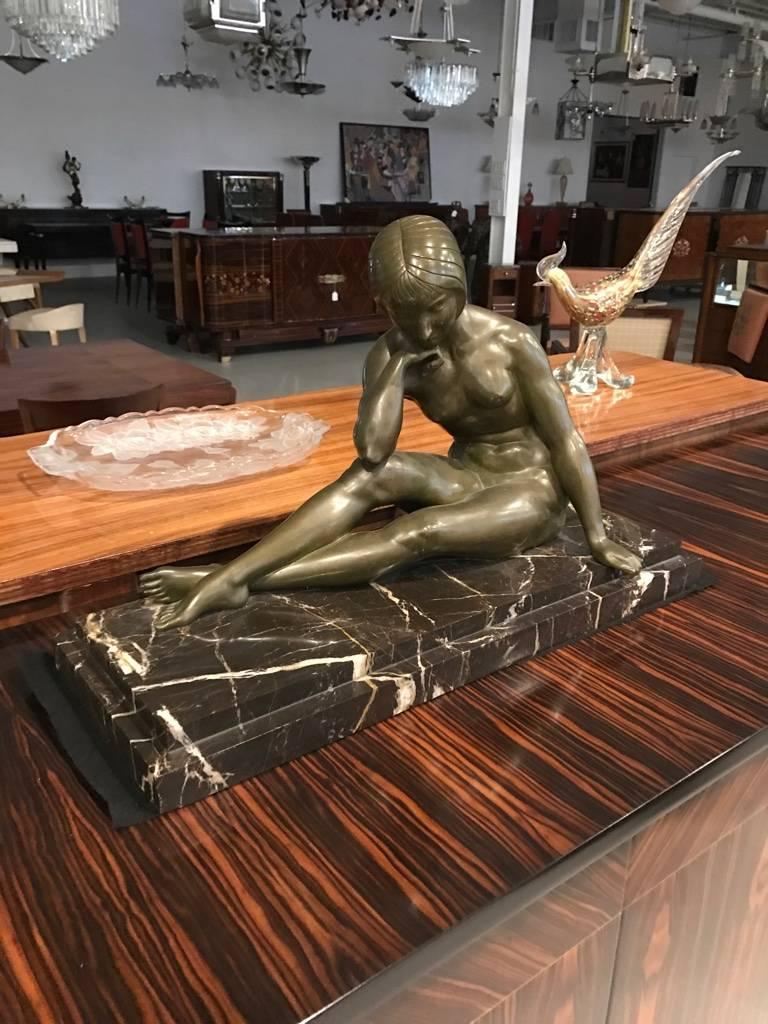 Stunning French Art Deco bronze sculpture of nude seated female signed by J.P. Morante. The bronze is a beautiful green patina on stepped marble base.