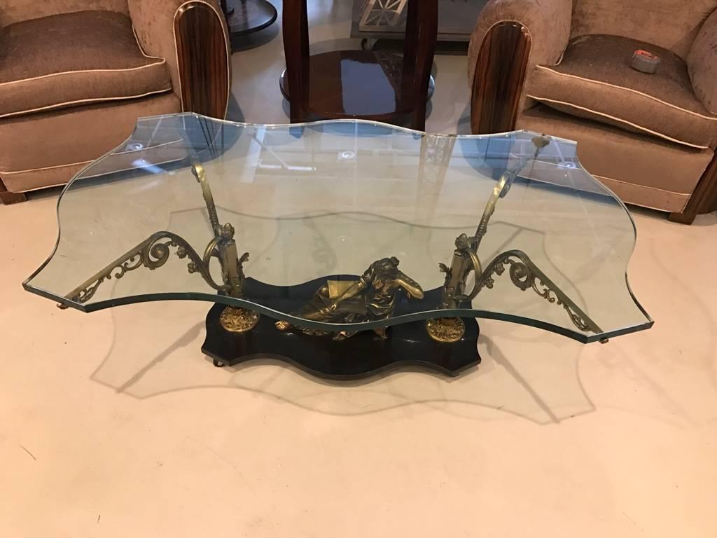 Stunning French Art Nouveau or Art Deco cocktail table. Having beautiful brass sitting female sculpture on marble base. With glass top and brass hardware.