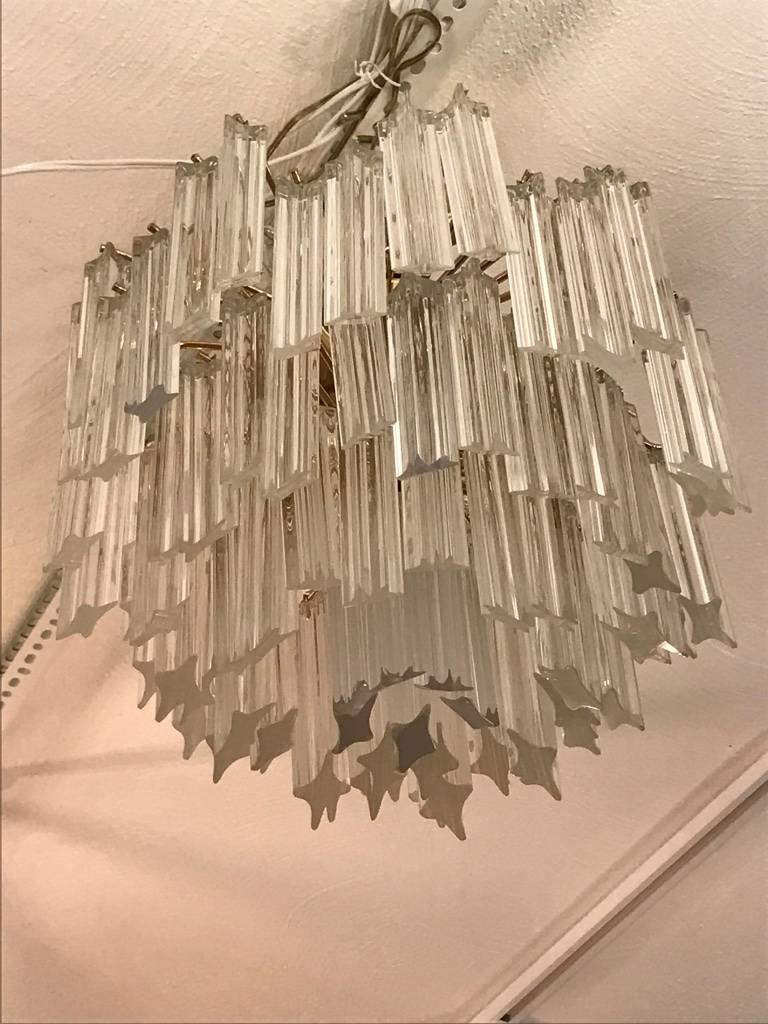Stunning Mid-Century Modern Italian chandelier by Camer. Each of the prisms are solid glass. They hang from hooks onto a brass frame, as pictured. Any amount of chain can be added for custom hanging length of the chandelier. Measures: Height without