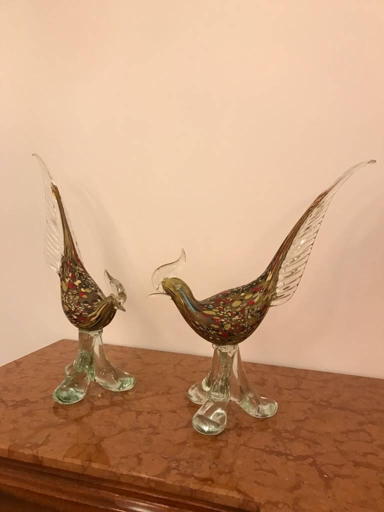 Pair of Italian Mid-Century Modern Murano handblown glass roosters sculptures. Having beautiful multi colors and clear glass.