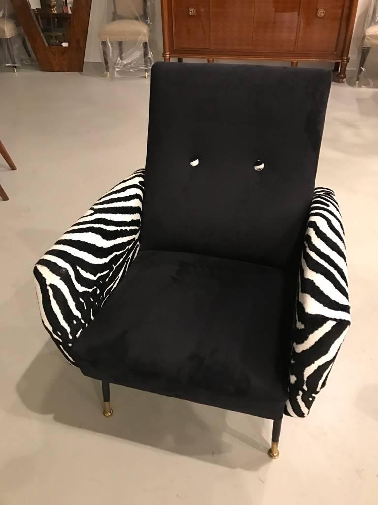 Stunning pair of black and zebra print upholstery chairs. Having black metal legs with brass caps.