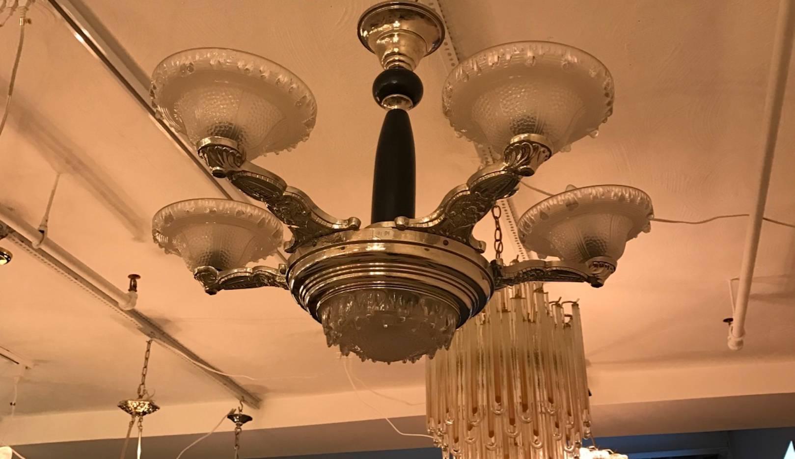 Stunning French Art Deco chandelier with five opalescent glass shades and opalescent centre bowl. The nickel bronze frame has a floral motif with an ebony wood shaft. Beautiful deco details.
 