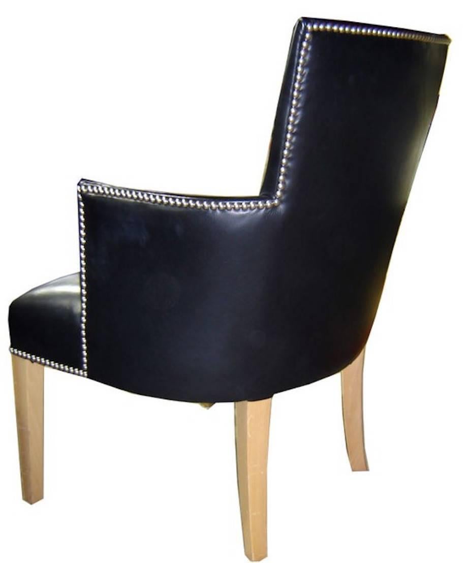 A comfortable French Art Deco armchair from the 1930s. The pale beechwood legs contrast with the soft black Edelman leather upholstery. Add the silver studs in Greek Key pattern and you have French elegance at its very best.