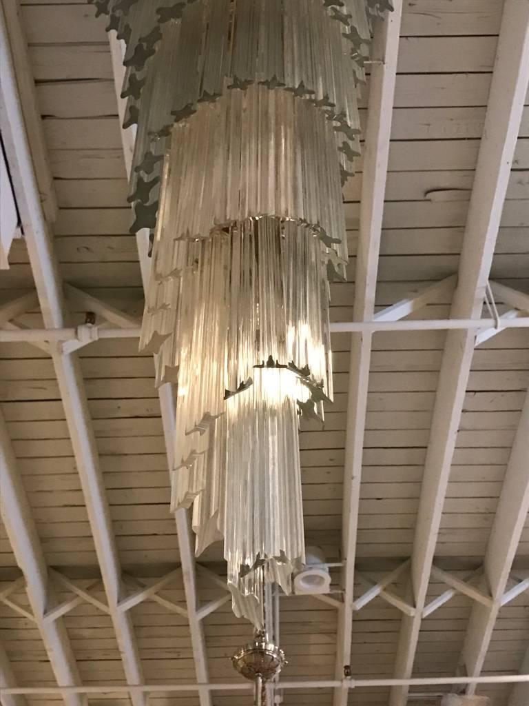 Stunning Mid-Century Modern Italian spiral chandelier. Each of the prisms are solid glass. They hang from hooks onto a spiral brass frame, as pictured. Any amount of chain can be added for custom hanging length of the chandelier. 

Measures: Height