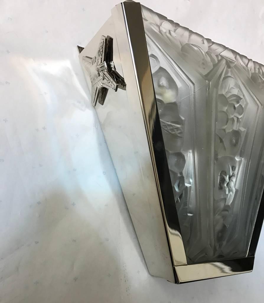 Stunning pair of French Art Deco sconces by Verrerie des Hanots in clear frosted glass shades with flower motif details throughout. Held by a silvered bronze design frame. Having the original 