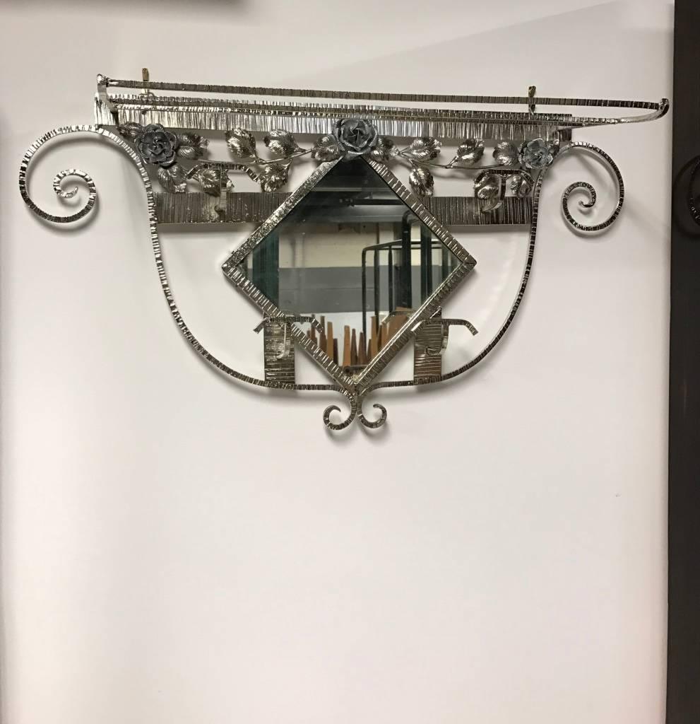 This amazing French Art Deco coat rack with central mirror and hat rack has beautiful details including floral design throughout. Having four coat hangers along with hat rack. 