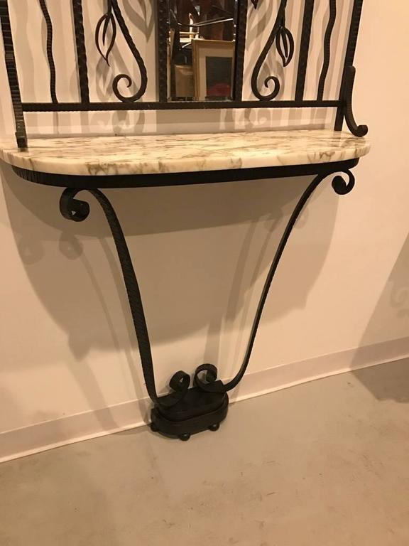 Beautiful French Art Deco console table. Having marble-top with a wrought iron mirror above. Stunning scroll work with gorgeous deco details. 

Console:
36 in.H x 35.5 in.W x 10.5 in.D

Mirror:
64 in.H x 32 in.W x 4.5 in.D.
 
 