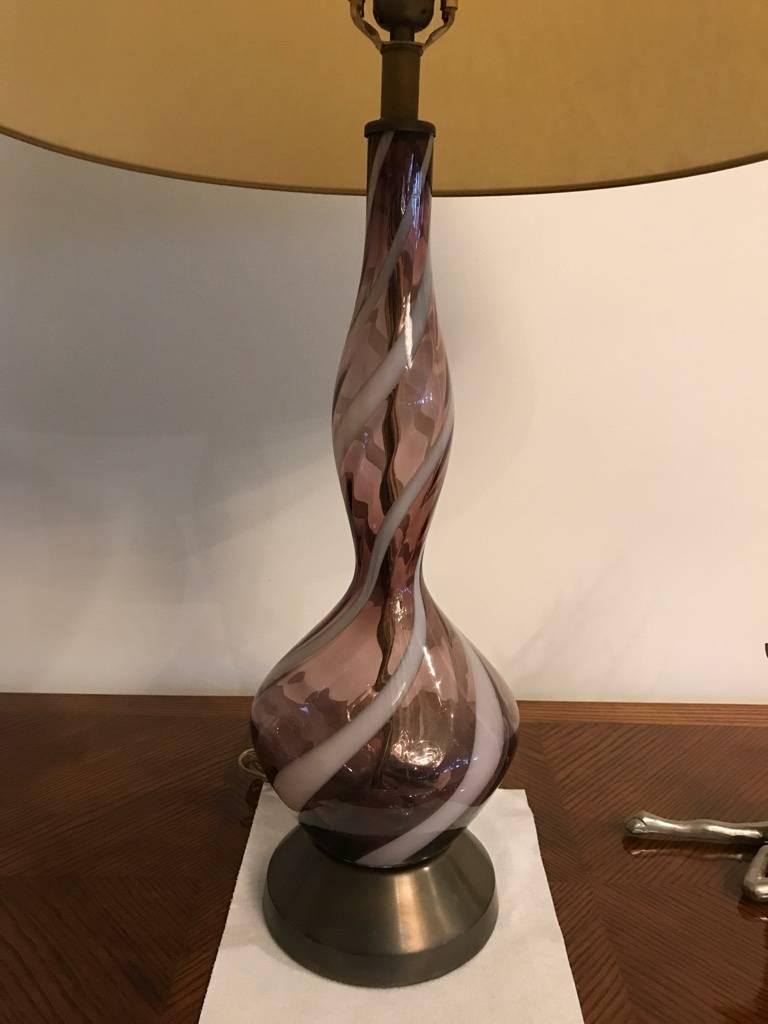 Stunning pair of Italian Mid-Century Modern Venetian table lamps. In colored glass swirl design, purple, white and clear. Having a brass base that matches the trim of the lamp shade.