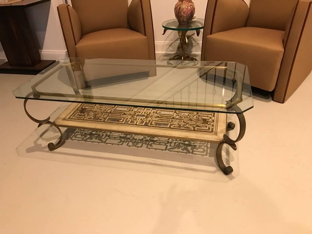 Mid-Century Modern brass and giltwood coffee table. Having antique brass legs with a bottom hand-carved and painted giltwood shelf.
