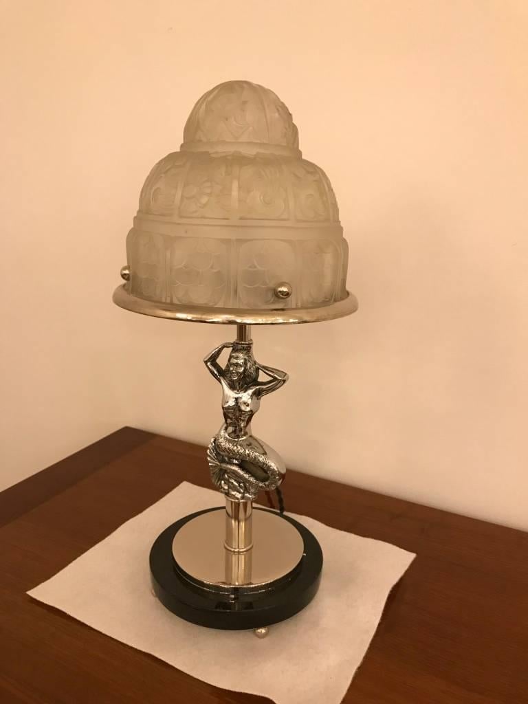 French Art Deco Mermaid table lamp by Genet et Michon. Having clear frosted glass with over flowing floral motif details. Supported by Mermaid with marble base.

 