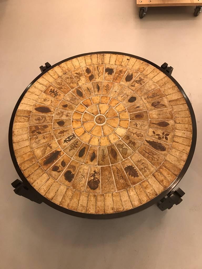 Beautiful French Mid-Century Modern coffee table signed by Roger Capron (1922-2006). Tabletop in Pietra Dura technique with 100 of ceramic panels of different individually pressed in original tree-leaves. Original condition. Raised on jointed and