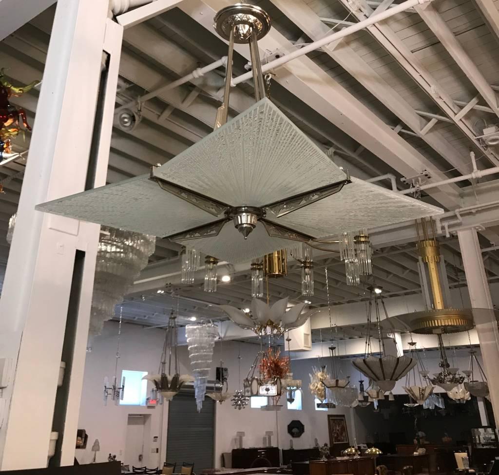 Beautiful French Art Deco chandelier with Lalique style glass panels, 1920s, French Art Deco geometric frame has been re plated in polished nickel. Having incredible Deco details and design. The four glass panels were created (2017) to compliment