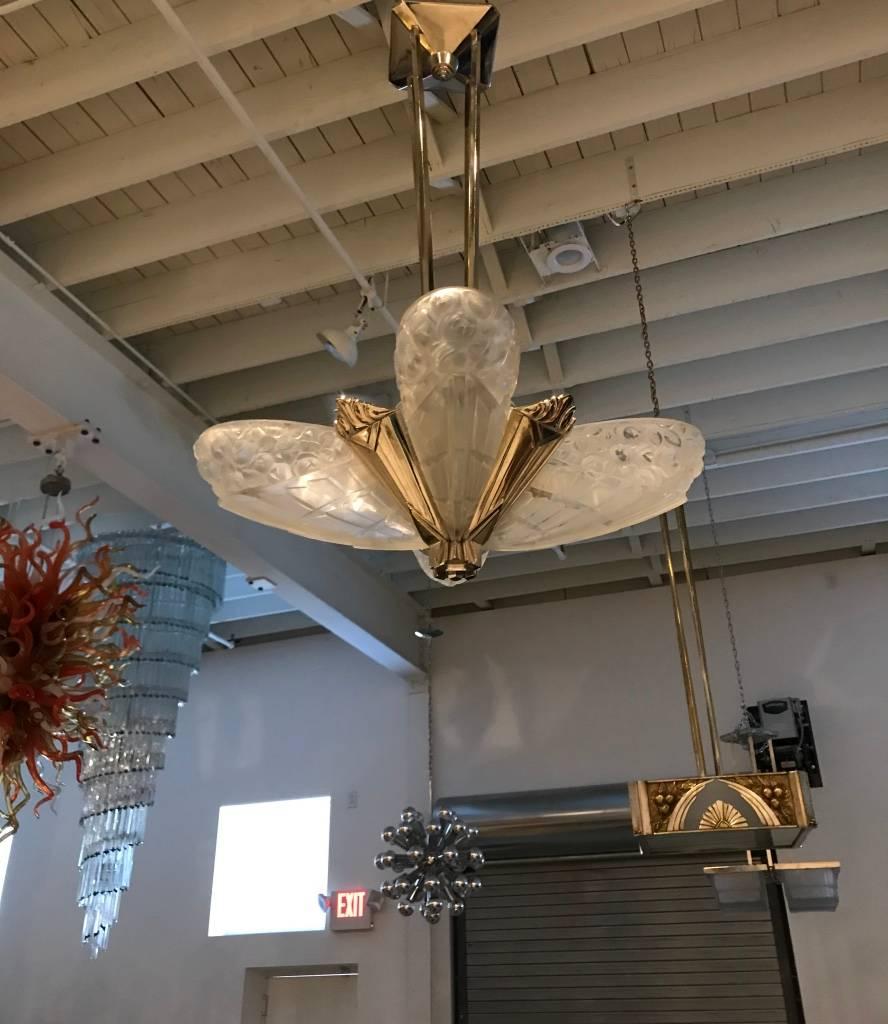 French Art Deco chandelier by the French artist J Robert. Shades are in clear frosted glass with geometric and floral design details. Shades rests on a geometric designed frame in nickel bronze. Re plating upon request. Has been rewired for American