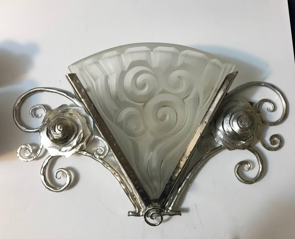 Stunning pair of French Art Deco wall sconces by the French artist “Degue” in clear frosted glass shades with geometric motif. Held by Nickeled Deco bronze frame.