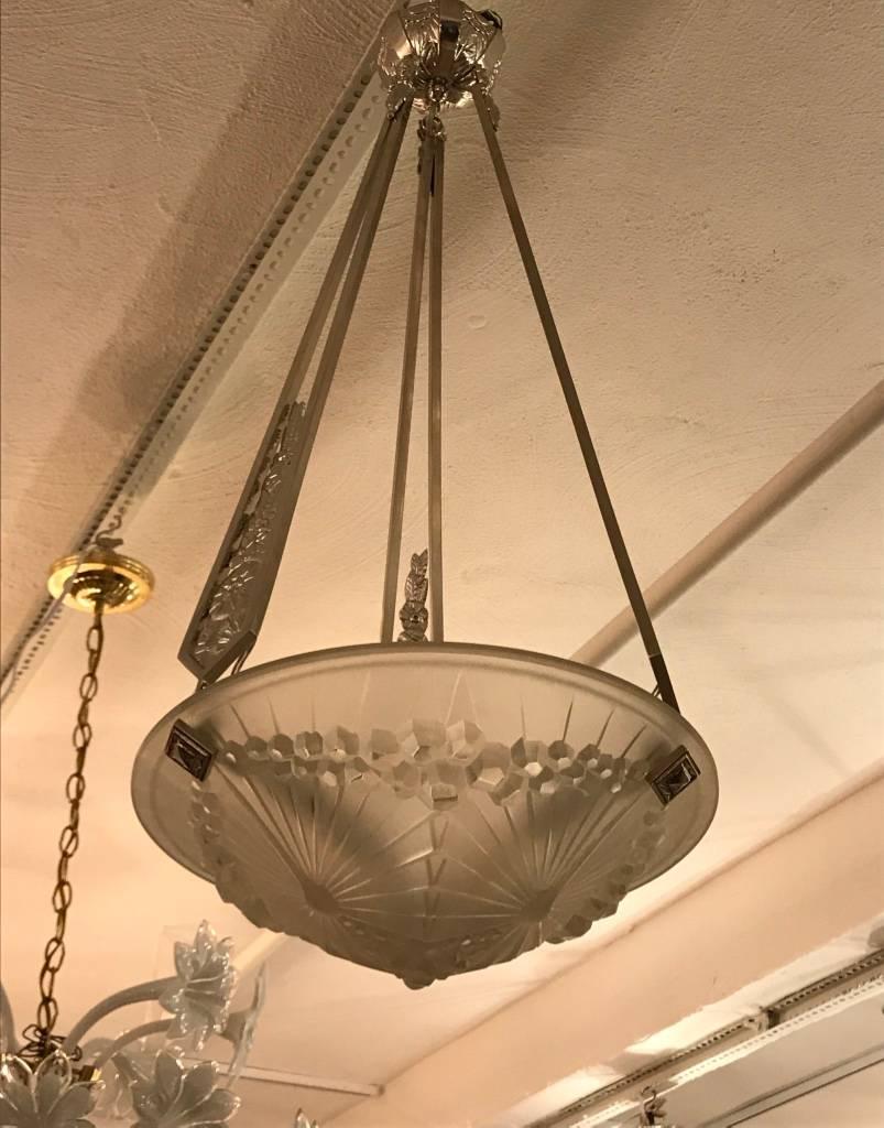 Stunning French Art Deco chandelier "Dragonfly" signed by the French artist "Charles Schneider". Having clear frosted glass shades with intricate geometric motif. The frame has been plated in polished nickel with beautiful
