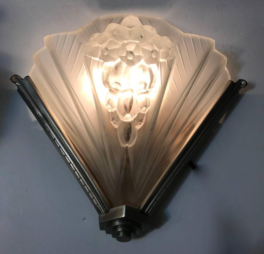 Pair of French Art Deco signed Atelier Petitot sconces. Shades are in clear frosted glass with over flowing intricate pomegranate motif details. Each shade is marked 