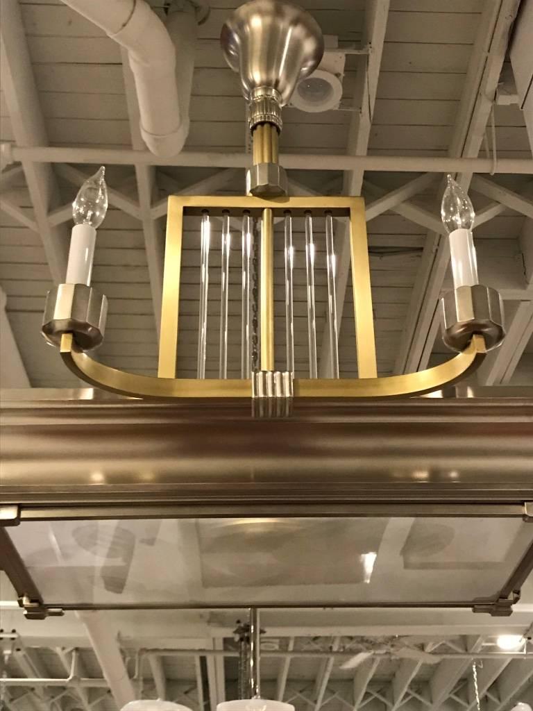 Beautiful French Art Deco modernist two-tone chandelier. Polished details mounted on a nickel and brass frame. The shaft having glass rods. The chandelier gives off beautiful amount of light.
