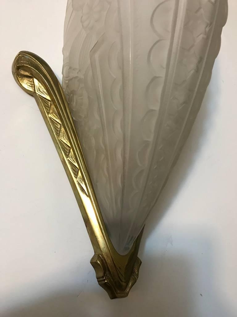 A beautiful pair of French Art Deco wall sconces signed by the French artist 