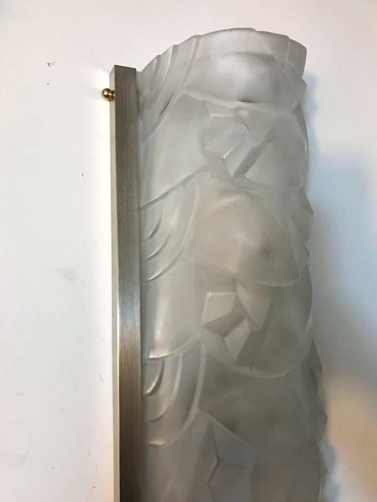 Grand pair of French Art Deco wall sconces by the French artist “Degue” in clear frosted glass shades with geometric and floral motif. Each shade is marked Degue, France, held by Nickeled frames. Replating upon request.