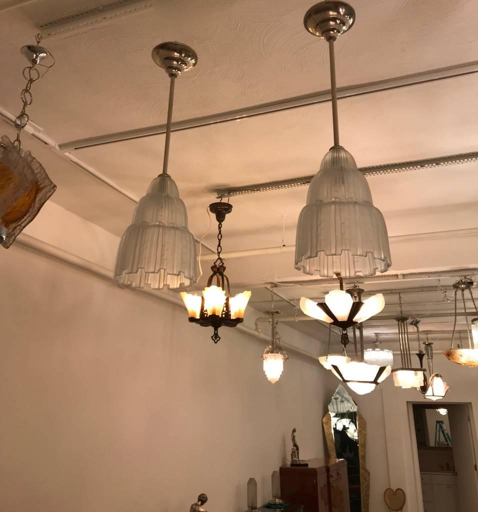 Pair or single French Art Deco chandeliers created by French artist Marius Ernest Sabino. These shade are known as the 