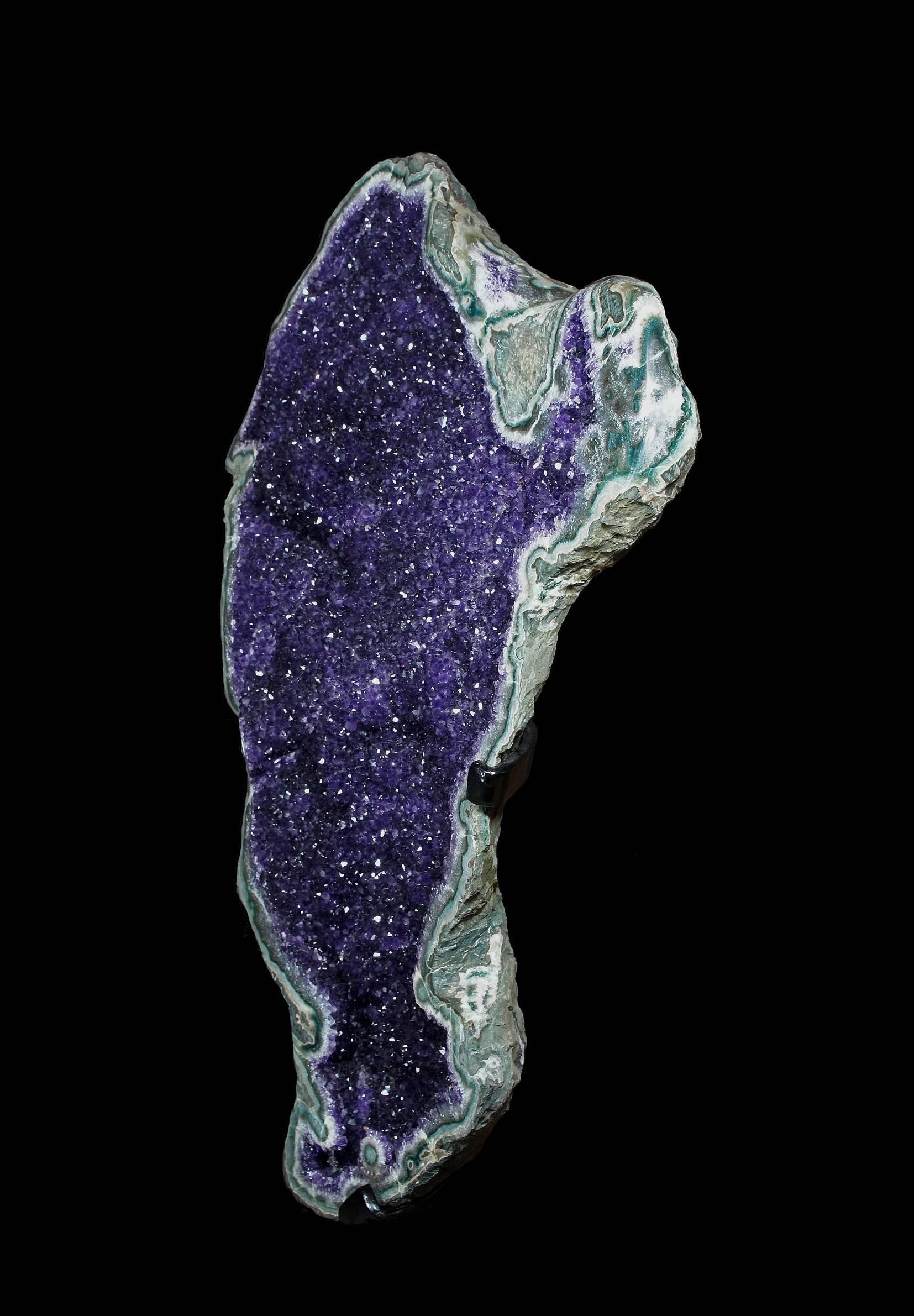 An open, shallow geode lined with sparkling deep purple crystals of Amethyst and polished agate border,
Uruguay.

Measures: H 89 x W 46.7 x D 13.5cm (with stand).
 